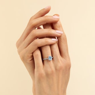 Goldsmiths 18ct White Gold 0.20cttw Diamond Blue Topaz Halo Ring Goldsmiths 18ct White Gold 0.20cttw Diamond Blue Topaz Halo Ring