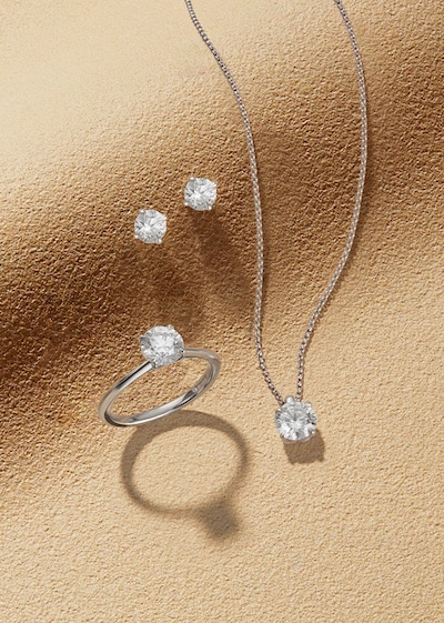 Goldsmiths Signature Diamond White Gold Jewellery on sandy background image